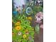Charming garden featuring vibrant zinnias, roses, and whimsical decorations at 226 Saul Dr, Ellenwood, GA 30294