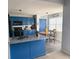 Bright kitchen featuring blue cabinetry, granite countertops, and an adjacent breakfast nook at 226 Saul Dr, Ellenwood, GA 30294