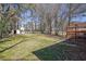 Large backyard featuring a shed and a wooden structure, surrounded by mature trees and lush greenery at 4391 Shiloh Hills Dr, Snellville, GA 30039