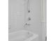 Close up of a shower-tub combo with white tile surround at 4391 Shiloh Hills Dr, Snellville, GA 30039