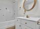 Bathroom features a tub, tile detail, and vanity with gold fixtures at 4391 Shiloh Hills Dr, Snellville, GA 30039