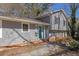 Two-story home featuring a light blue front door, gray siding, and a landscaped yard at 4391 Shiloh Hills Dr, Snellville, GA 30039