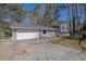 Charming gray house with an attached garage and a concrete driveway at 4391 Shiloh Hills Dr, Snellville, GA 30039