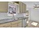 Well-lit kitchen with stainless steel sink, white subway tile, and updated appliances at 4391 Shiloh Hills Dr, Snellville, GA 30039
