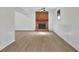 Spacious living room featuring a brick fireplace, new flooring and neutral walls at 4391 Shiloh Hills Dr, Snellville, GA 30039