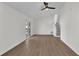 Open-concept living room with hardwood floors, a ceiling fan, and a sliding glass door to the backyard at 4391 Shiloh Hills Dr, Snellville, GA 30039