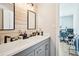 Modern bathroom featuring double sinks, matte black fixtures, and stylish wood accent wall at 8 Pine Canyon Sw Dr, Atlanta, GA 30331