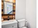 Half bath with updated vanity, decorative mirror and modern fixtures at 8 Pine Canyon Sw Dr, Atlanta, GA 30331