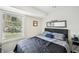 Serene bedroom with a large window, sleek dark furniture, and modern decor for a relaxing retreat at 8 Pine Canyon Sw Dr, Atlanta, GA 30331