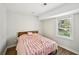 Charming bedroom with a window view, cozy bed, and wood floors for a comfortable space at 8 Pine Canyon Sw Dr, Atlanta, GA 30331