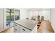 Open kitchen with center island, granite countertops, and sliding glass door at 8 Pine Canyon Sw Dr, Atlanta, GA 30331