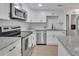 Modern kitchen with white cabinets, granite countertops, and stainless steel appliances at 8 Pine Canyon Sw Dr, Atlanta, GA 30331