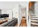 Bright living room with modern finishes, hardwood floors, and staircase access at 8 Pine Canyon Sw Dr, Atlanta, GA 30331