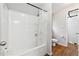 A clean white bathroom features a tub-shower combo and tile flooring at 1042 Wedgewood Ct, Conyers, GA 30012