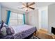 This bedroom is sunlit and features wood flooring, a large window, and blue accents at 1042 Wedgewood Ct, Conyers, GA 30012