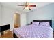 This bright bedroom features wood flooring, a ceiling fan, and an open doorway at 1042 Wedgewood Ct, Conyers, GA 30012