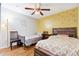 Cozy bedroom featuring two beds, a ceiling fan, and unique wall decor at 1042 Wedgewood Ct, Conyers, GA 30012