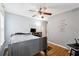 Bedroom with bed, ceiling fan, motivational wall art, and wood-look flooring at 1042 Wedgewood Ct, Conyers, GA 30012