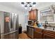 The kitchen has stainless steel appliances, wooden cabinets, and tile backsplash at 1042 Wedgewood Ct, Conyers, GA 30012