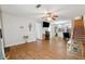 A well-lit living room featuring an open floor plan with hardwood floors and a ceiling fan at 1042 Wedgewood Ct, Conyers, GA 30012