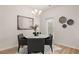 Dining room with a chandelier, a white marble table and grey chairs with art hanging on the walls at 1189 Westhampton Dr # 147, Villa Rica, GA 30180