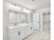Modern bathroom featuring a double sink vanity, a large mirror, and tile flooring at 5769 Tillman Way, Powder Springs, GA 30127