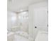 Bright bathroom featuring a glass enclosed shower with marble-style tile surround at 5769 Tillman Way, Powder Springs, GA 30127