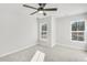 Spacious bedroom with a ceiling fan, two windows and neutral carpeting at 5769 Tillman Way, Powder Springs, GA 30127