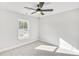 Bright bedroom with a ceiling fan, a window and neutral carpeting at 5769 Tillman Way, Powder Springs, GA 30127