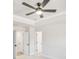 Bedroom with tray ceiling, ceiling fan, and multiple doors at 5769 Tillman Way, Powder Springs, GA 30127