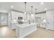 Modern kitchen with white cabinets, quartz countertops, stainless steel appliances, and center island at 5769 Tillman Way, Powder Springs, GA 30127