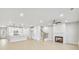 Open concept living space featuring a fireplace, stairs, and a modern white kitchen at 5769 Tillman Way, Powder Springs, GA 30127