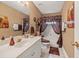 Cozy bathroom features a white vanity, framed mirror, decorative accents, and neutral wall color at 1070 River Valley Dr, Dacula, GA 30019