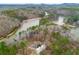 Picturesque aerial shot of a lake community surrounded by lush, mature woods at 30 Crolley Ln, White, GA 30184