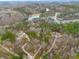 Beautiful aerial view of homes in a wooded area near a tranquil lake at 30 Crolley Ln, White, GA 30184