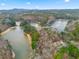 Scenic aerial view of lake houses surrounded by dense, beautiful forest and water at 30 Crolley Ln, White, GA 30184