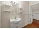 Charming bathroom with a pedestal sink, tile floor, and decorative shelves at 30 Crolley Ln, White, GA 30184
