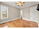 Cozy bedroom with hardwood floors, a ceiling fan, and a large window at 30 Crolley Ln, White, GA 30184