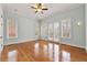 Bright bedroom with hardwood floors, ceiling fan, and French doors leading to a private balcony at 30 Crolley Ln, White, GA 30184