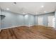 Spacious bedroom with light blue walls, wood floors, ceiling fan, and two white doors at 30 Crolley Ln, White, GA 30184