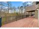 Wooden deck with black metal railing overlooking trees at 30 Crolley Ln, White, GA 30184