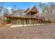 Two-story home featuring a large deck, covered patio, and a spacious backyard, perfect for outdoor entertaining at 30 Crolley Ln, White, GA 30184
