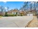 Sprawling home boasts attached garages and a long circular driveway, surrounded by mature trees at 30 Crolley Ln, White, GA 30184