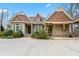 Charming home featuring stone accents, covered porch, and mature landscaping with circular driveway at 30 Crolley Ln, White, GA 30184