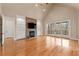 Bright and spacious living room featuring hardwood floors, stone fireplace, and balcony access at 30 Crolley Ln, White, GA 30184