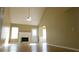 Sunlit living room with vaulted ceiling, fireplace, hardwood floors, and a ceiling fan at 705 Freeman Dr, Covington, GA 30016