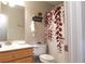 Cozy bathroom with light wood vanity, framed mirror, and decorative shower curtain at 132 Hammond Dr, Canton, GA 30114