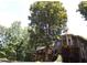Back of the house with a deck, lush trees and green grass surrounding it at 132 Hammond Dr, Canton, GA 30114