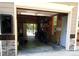Garage with open door, motorcycle inside, and electric charger on the outside wall at 132 Hammond Dr, Canton, GA 30114