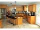 Well-equipped kitchen with wooden cabinetry, granite countertops, stainless steel appliances and breakfast bar at 132 Hammond Dr, Canton, GA 30114